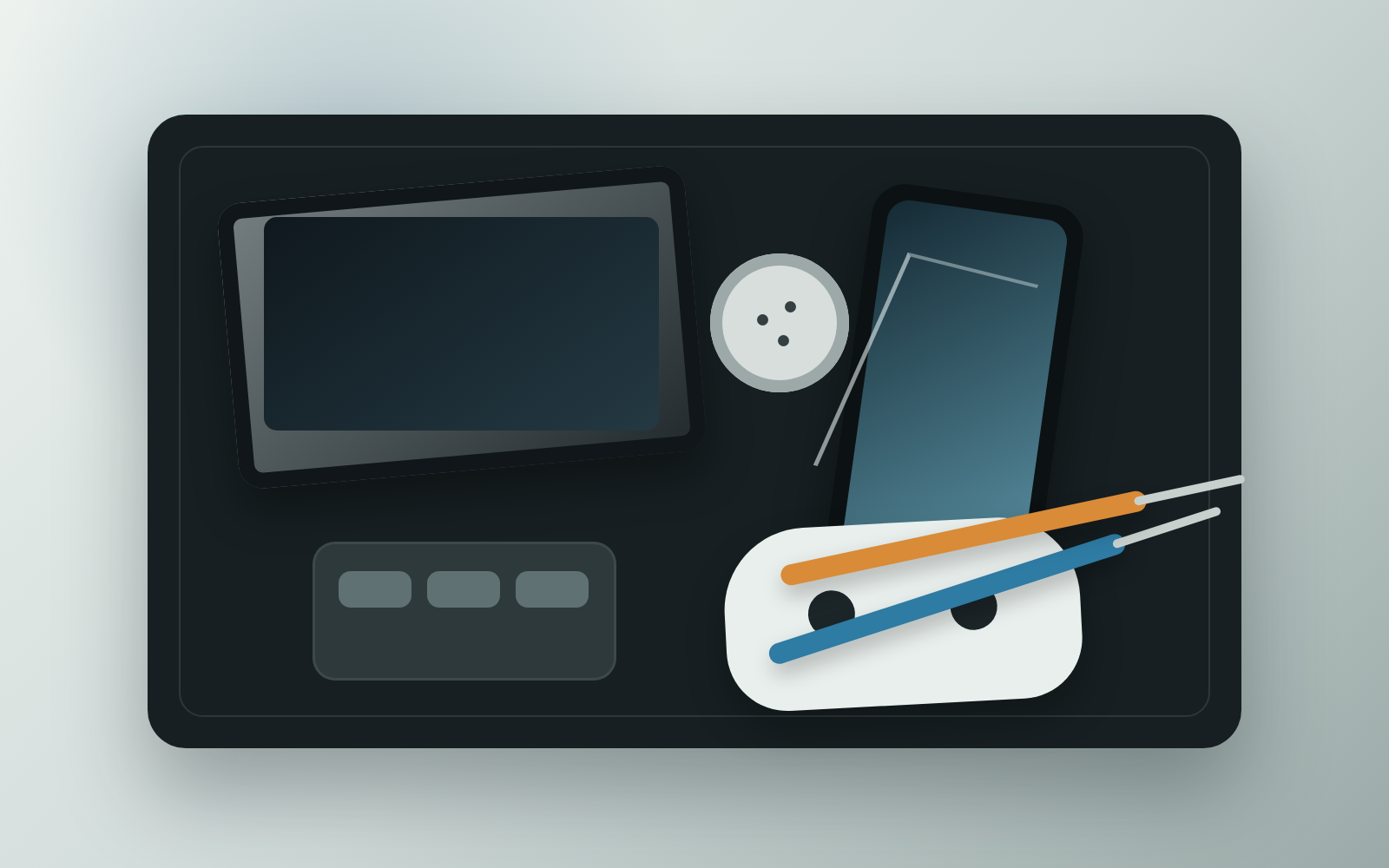 A repair tray with a phone, laptop, controller, small parts, and tools.